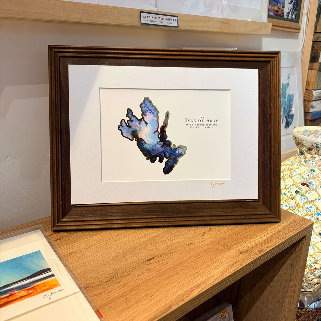 blue watercolour map of the isle of skye with gold outline in a frame