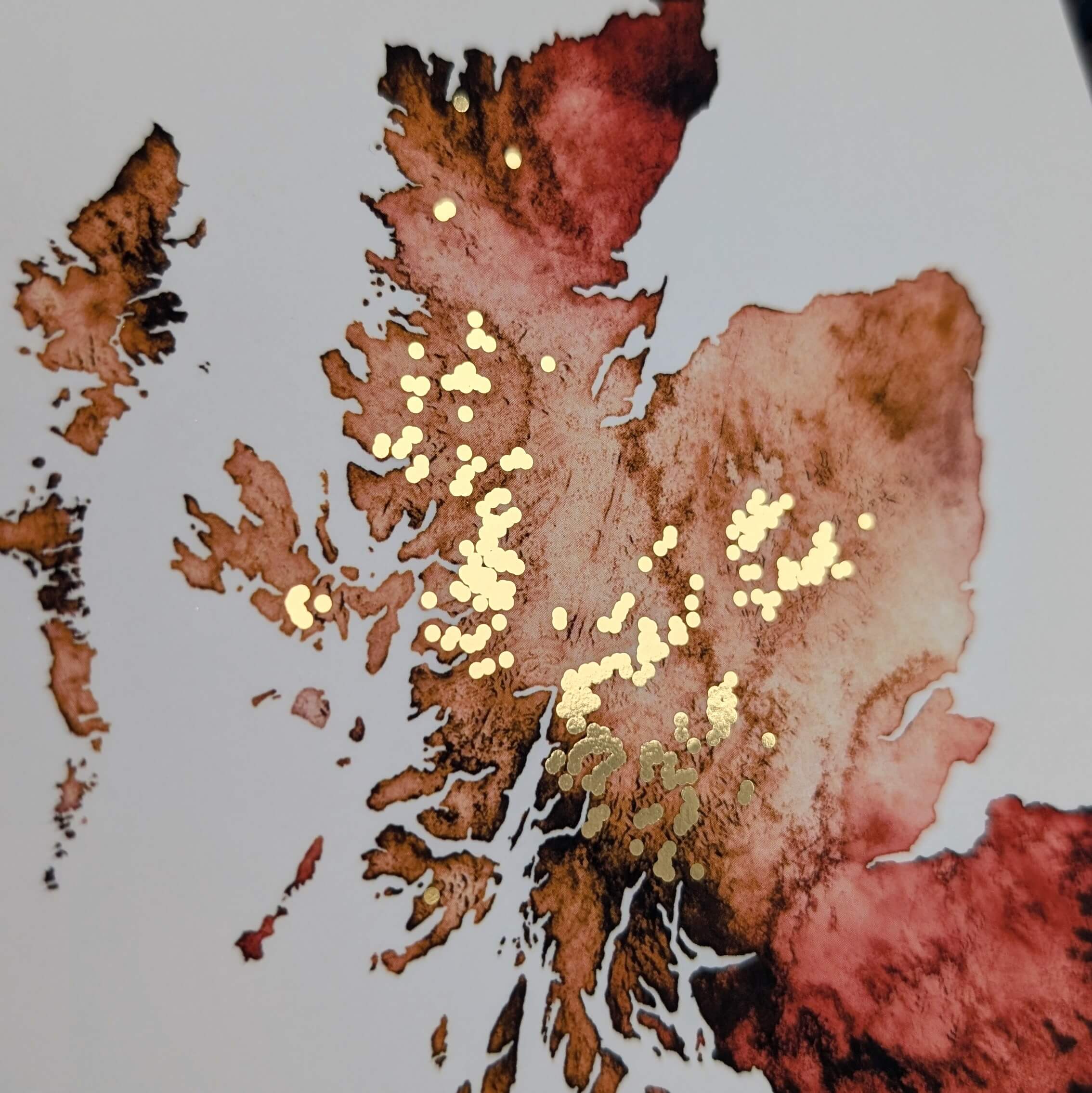 an orange watercolour map of Scotland with all the munro mountains in gold. perfect gift for a munro bagger