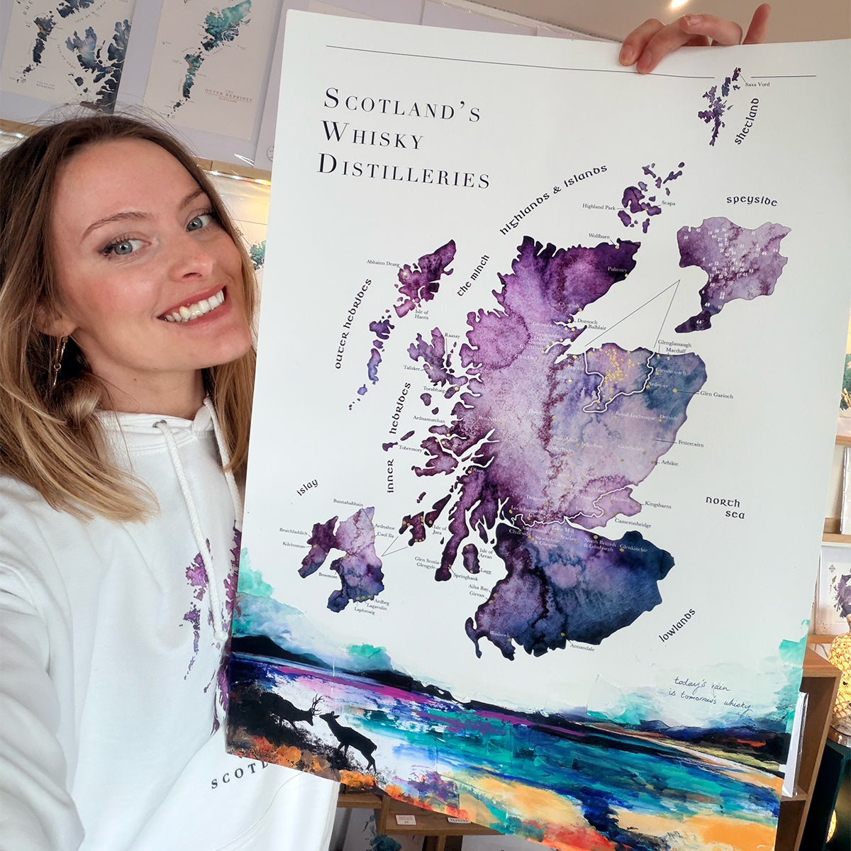 Woman holding a large map of Scotland's whisky distilleries