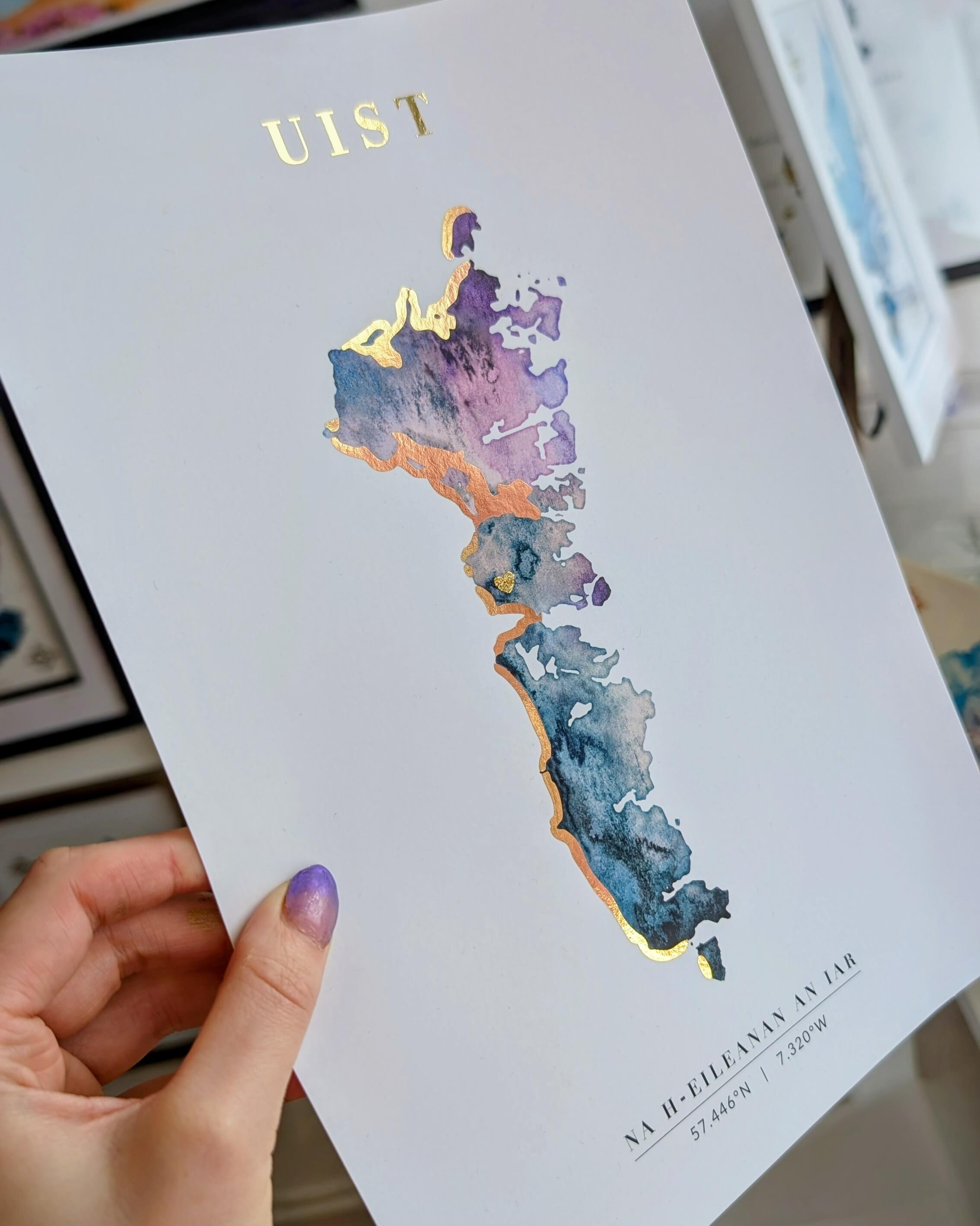 Close-up of a hand-painted map of Uist, part of the Outer Hebrides, with purple and blue watercolour tones