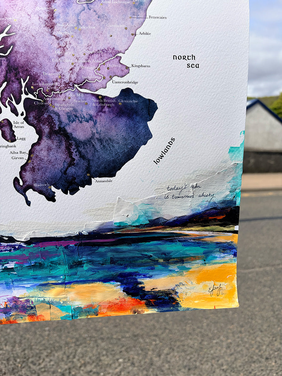 Colorful abstract art piece on a street with a map of Scotland in the background