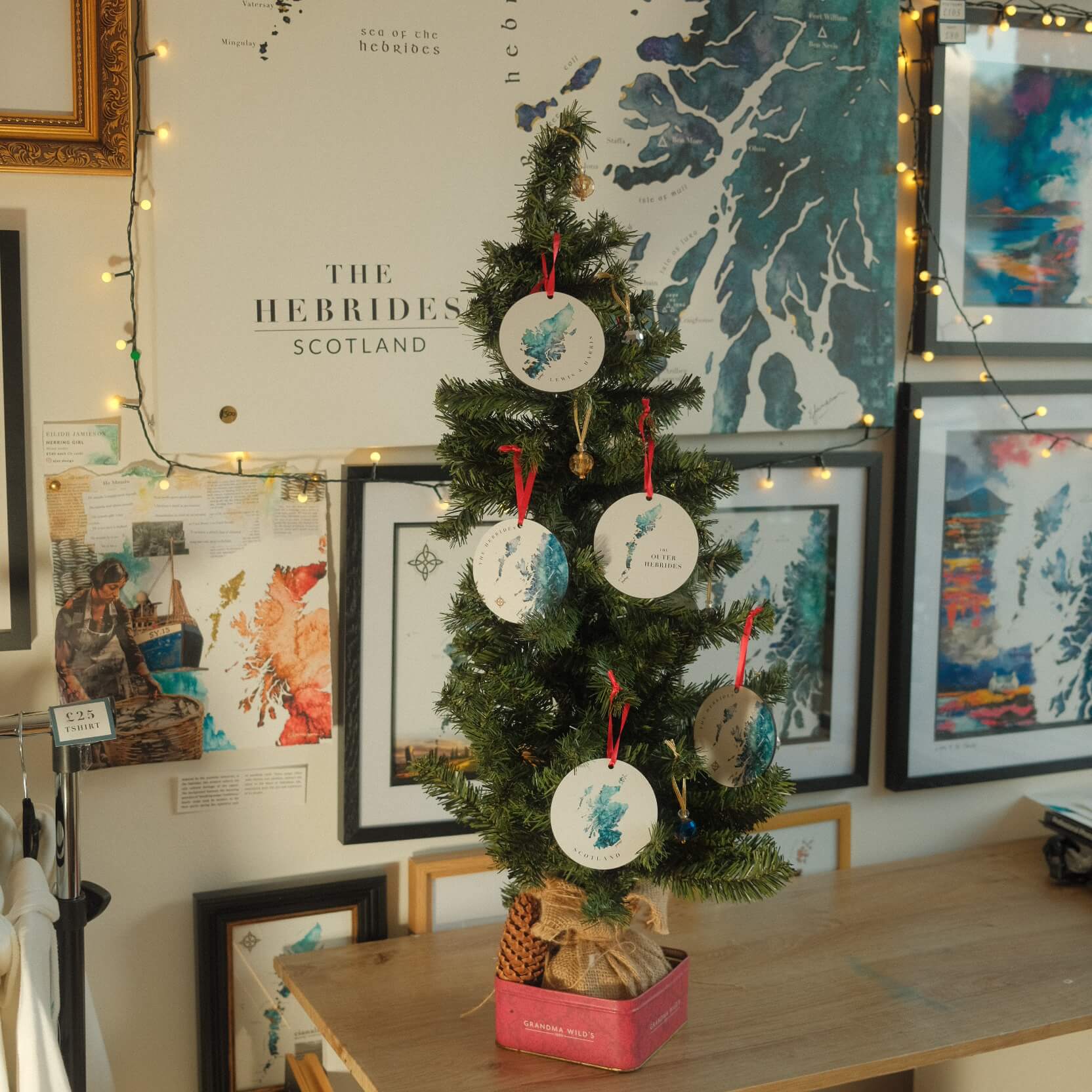 Double-sided MDF Christmas bauble featuring a watercolor maps of Scotland and Scottish Islands with a red ribbon, perfect for festive decoration and art lovers.